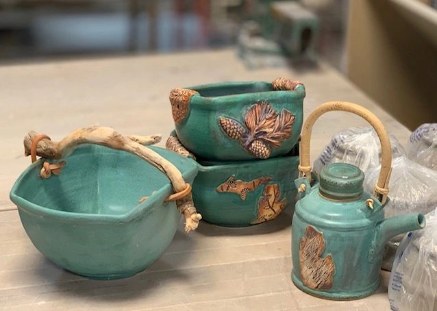 Colorful ceramic vessels with teal glaze