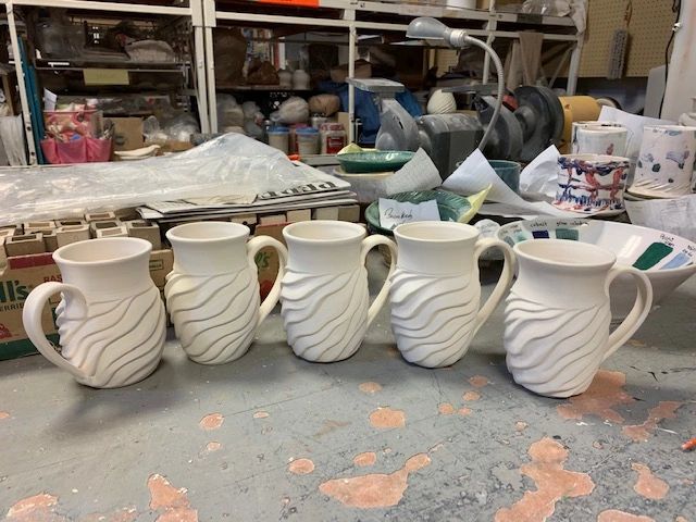 Ceramic pitchers in pottery studio